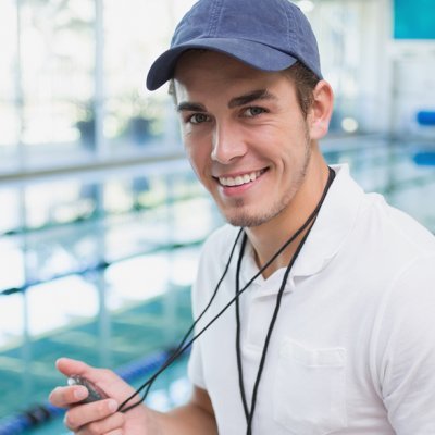 Handsome swimming instructor smiling at camera